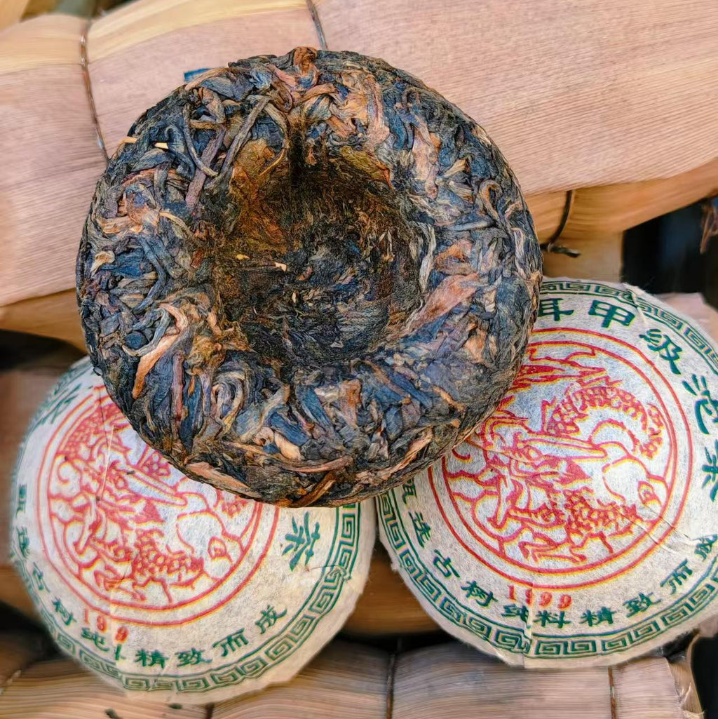 Traditional Chinese tea cake with red and green labels on a woven bamboo basket background